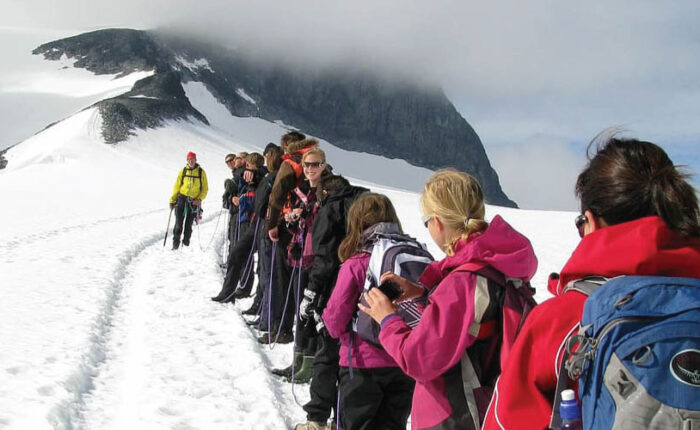 Marangu Route: Climbers celebrating at the highest point in Africa on Mount Kilimanjaro.