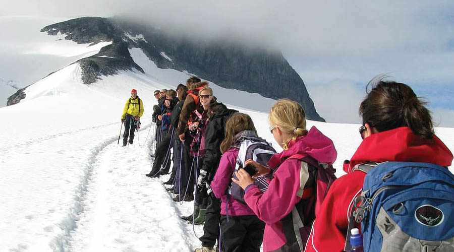 Marangu Route: Climbers celebrating at the highest point in Africa on Mount Kilimanjaro.