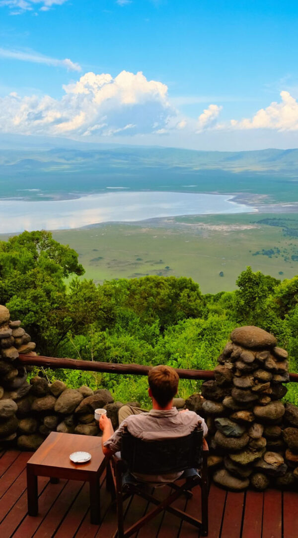 Visitor enjoying a scenic Ngorongoro Crater view from above, overlooking the vast caldera landscape.